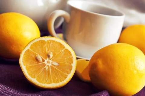 Lemon with cup of tea Stock Photos