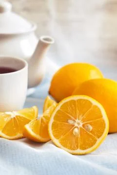 Lemon with cup of tea Stock Photos