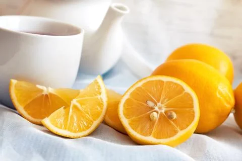 Lemon with cup of tea Stock Photos