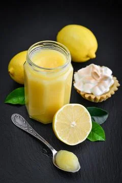 Lemon curd in jar with fresh lemons 写真素材