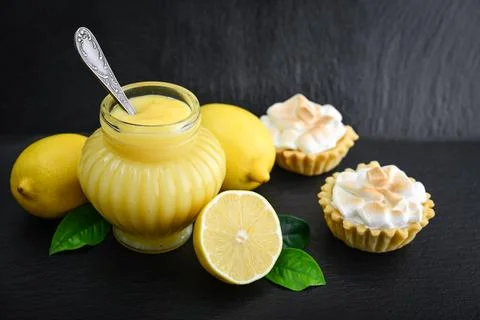 Lemon curd in jar with fresh lemons Stock Photos