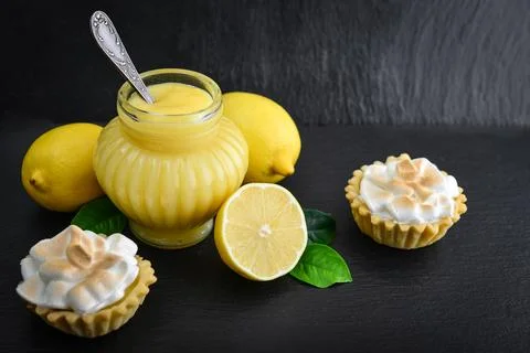Lemon curd in jar with fresh lemons Stock Photos