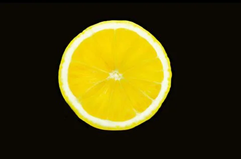 Lemon in a cut on a black background Stock Photos