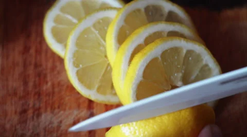 Lemon Cut on a Board With a Knife Stock Footage 64058108
