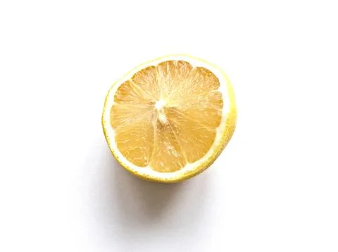 A lemon is cut in half and the inside is shown Stock Photos