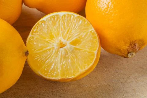 A lemon is cut in half and placed on a table Stock Photos
