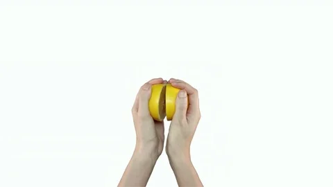 Lemon cut in half, held by hands on white background Stock Footage 71628560