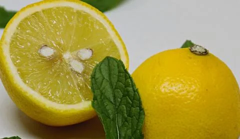 A lemon cut in half with mint Stock Photos