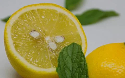 A lemon cut in half with mint Foto stock
