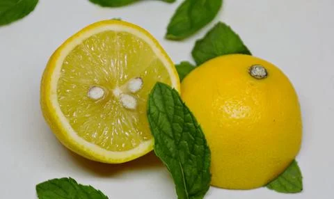A lemon cut in half with mint Stock Photos