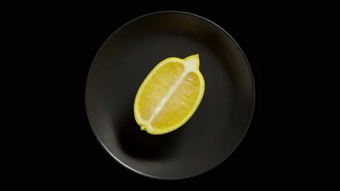 Lemon cut lengthwise, on grey plate 스톡 동영상 221983529