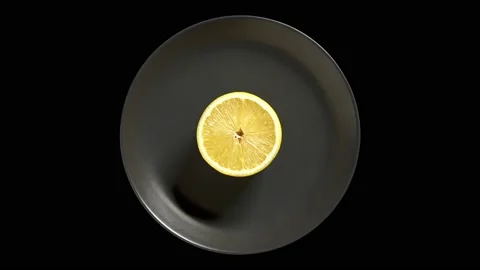 Lemon cut on round dark gray plate Stock Footage 209559840