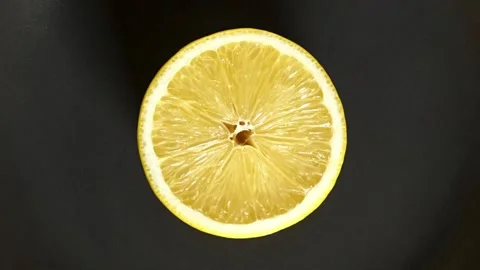Lemon cut on round dark grey plate 스톡 동영상 221983506