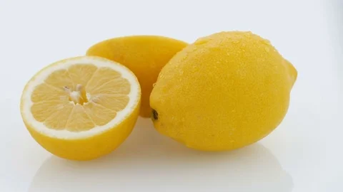 Lemon Cut on Turntable - White Background - Wet Stock Footage 75854830