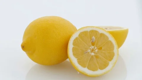 Lemon Cut on Turntable - White Background Stock Footage 75854848