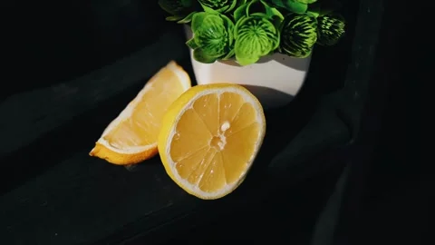 Lemon cut into two halves and decorated with greenery. Close-up shooting Stock Footage 336659489