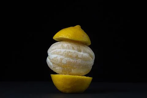 Lemon on a dark background. Peeled lemon on a black background.  Stock Photos