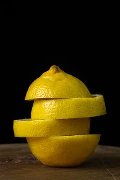 Lemon on a dark background. Sliced lemon on a black background. Stock Photos