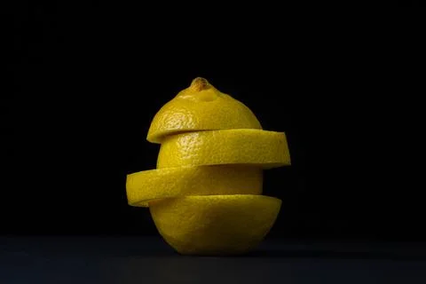 Lemon on a dark background. Sliced lemon on a black background. Stock Photos
