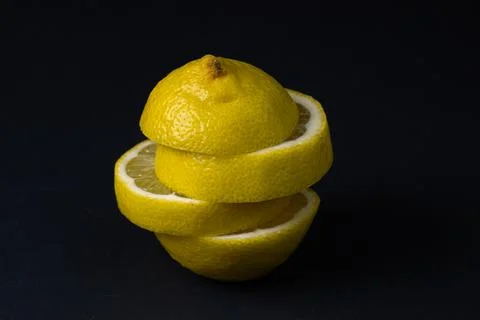 Lemon on a dark background. Sliced lemon on a black background. Stock Photos