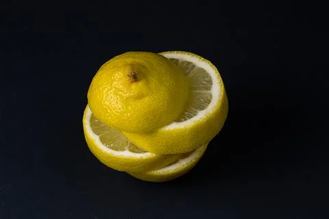 Lemon on a dark background. Sliced lemon on a black background. Stock Photos
