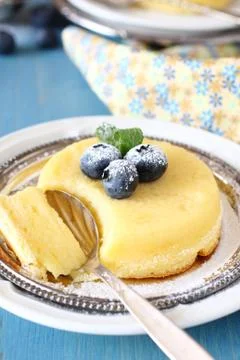 Lemon delicious pudding cake served with berries Stock Photos