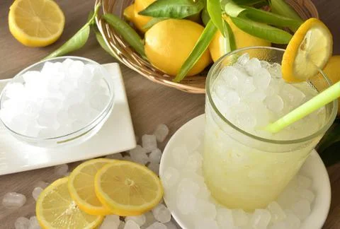 Lemon drink with lots of ice on table elevated view Stock Photos