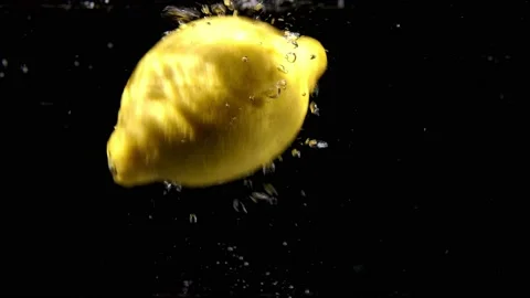 Lemon dropping in water - slow motion Stock Footage 156986714