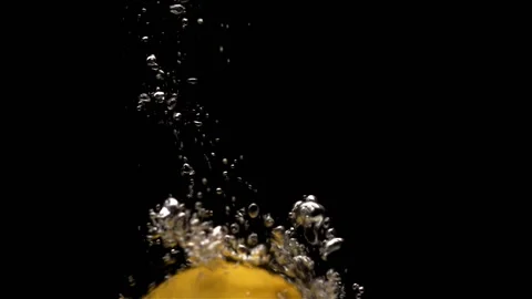 Lemon drops into water in slow motion Stock Footage 140255592