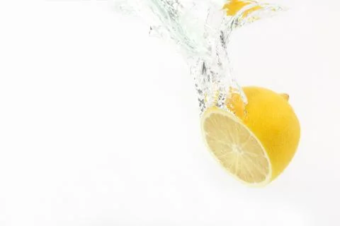 Lemon drops of water on white background Stock Photos