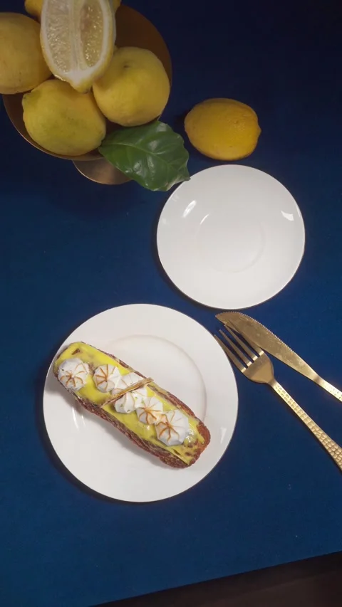 Lemon Eclair Dessert and Coffee Serving on Cafe Table Vertical Video Stock Footage 335422303
