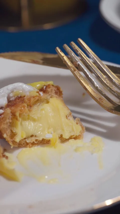 Lemon Eclair Dessert Slice with Caramel Drizzle on White Plate Close Up Vertical Stock Footage 335422288