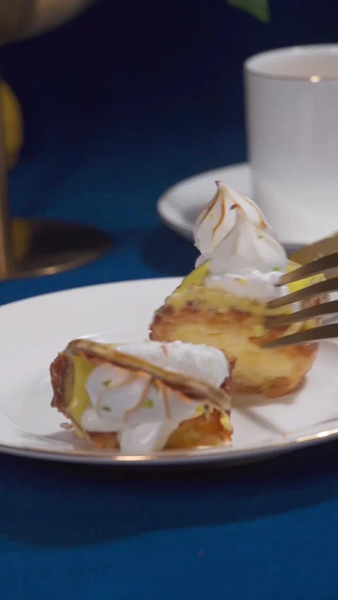 Lemon Eclair Dessert Slice Cutting on Cafe Table with Coffee and Fork Close Up Stock Footage 335422283