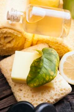 Lemon essential oil and lemon fruit on the wooden board Stock Photos
