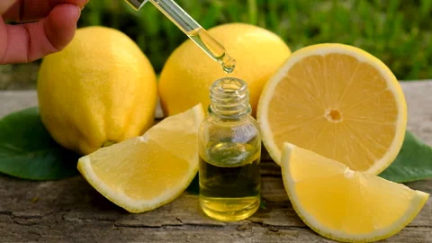 Lemon essential oil in a bottle. Selective focus. Stock Footage 312627606