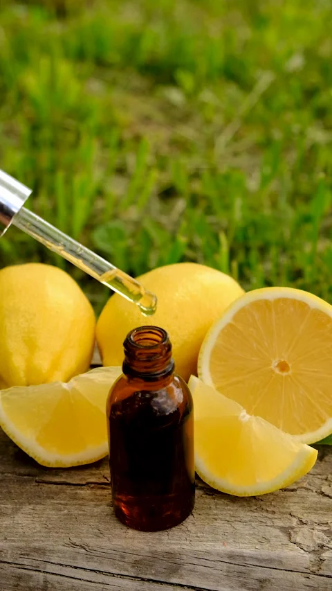 Lemon essential oil in a bottle. Selective focus. Stock Footage 313974194