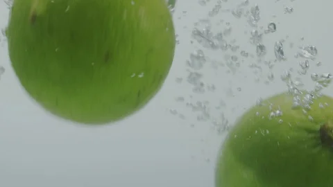 Lemon falling in water Stock Footage 98300233