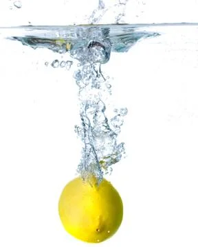 Lemon falling in water on white background. Stock Photos