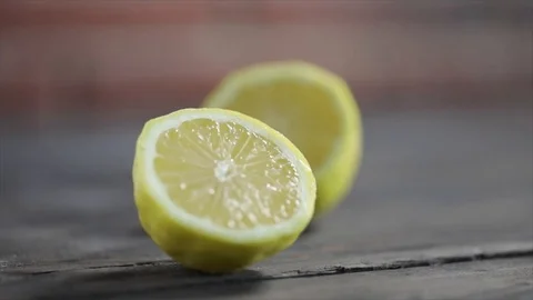 Lemon falls in 2 Halves Closeup Stock Footage 99165867