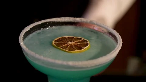 Lemon falls on the cocktail. Stock Footage 244941254