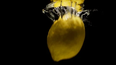 Lemon falls into cold water. Stock Footage 90386379