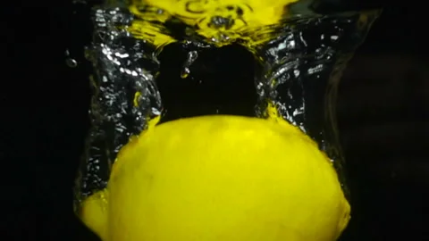 Lemon falls into the water, slow motion Stock Footage