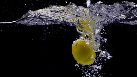 Lemon falls in the water in slow motion. Isolated on black background. Close up Stockbeeldmateriaal 123712493
