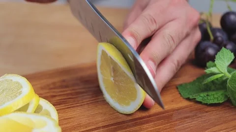 Lemon fruit cutting on the board for the lemonade or cocktail, extreme close up Stock Footage 158861489