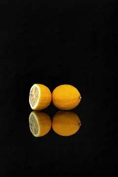 Lemon fruit reflection isolated on black background. Stock Photos