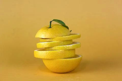 Lemon fruit slice in layers isolated on yellow background Stock Photos