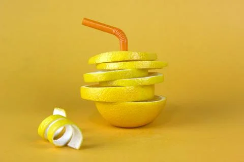 Lemon fruit slice in layers with peels isolated on yellow background. Juicy l Stock Photos