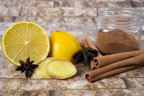 Lemon ginger cinnamon spices on rustic background Stock Photos