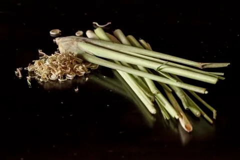Lemon grass stems with slice on dark wooden table Stock Photos