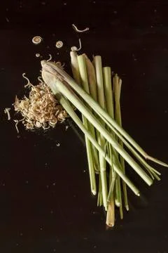 Lemon grass stems with slice on dark wooden table Stock Photos